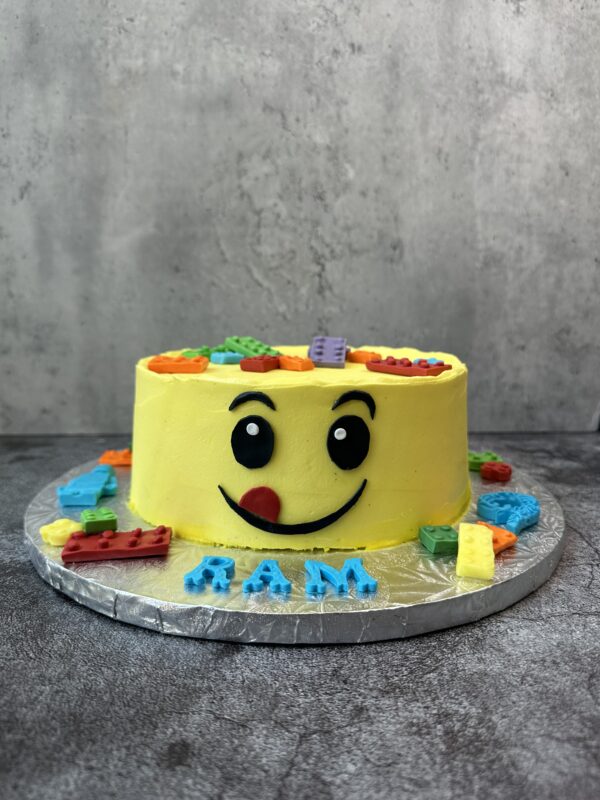 A yellow color smiley shapes cake