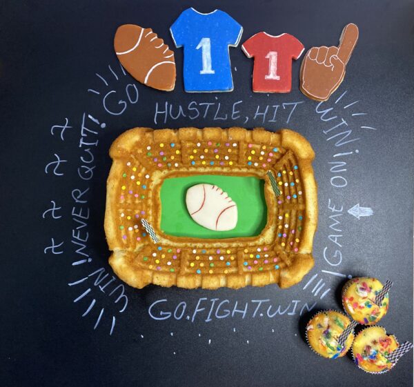 A cookie with a stadium design along with three cookies