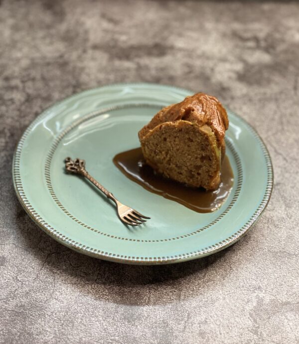 A slice of bunt cake in a mint-green plate