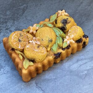 A cake with lemons and flowers