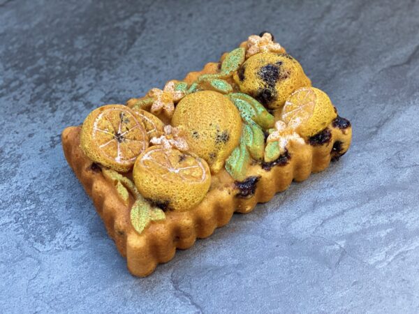 A cake with lemons and flowers