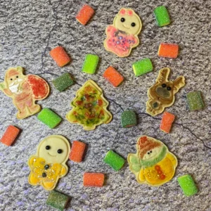 Pieces of cookies with gummies on floor