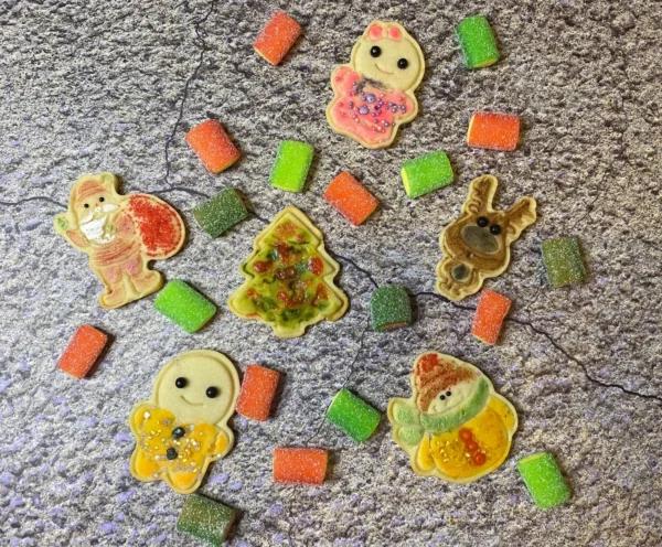 Pieces of cookies with gummies on floor