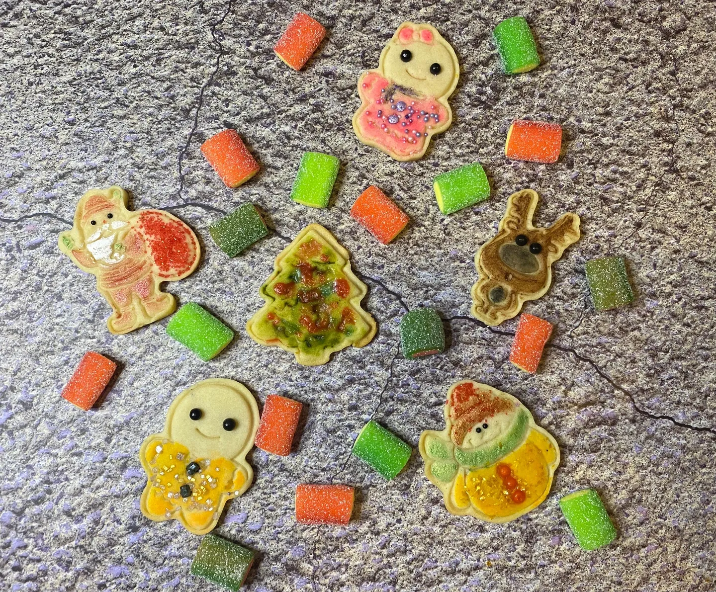 Pieces of cookies with gummies on floor