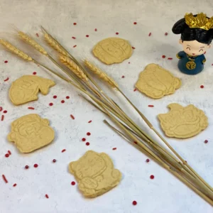 Cookies in different shapes with a small Chinese female figurine