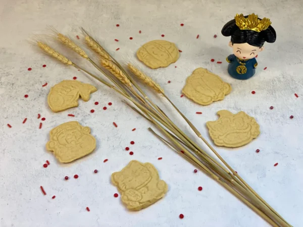 Cookies in different shapes with a small Chinese female figurine