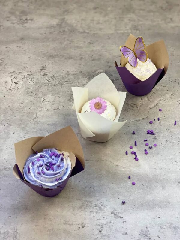 Three purple-themed cupcakes