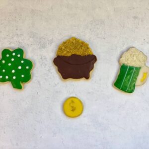 Four cookies in different shapes, such as beer, coin, pot, and tree