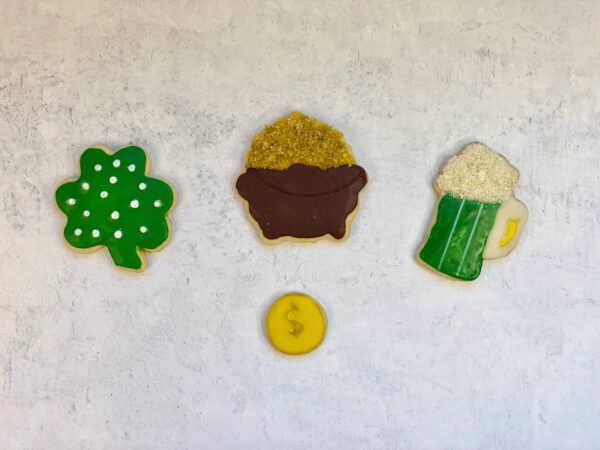 Four cookies in different shapes, such as beer, coin, pot, and tree