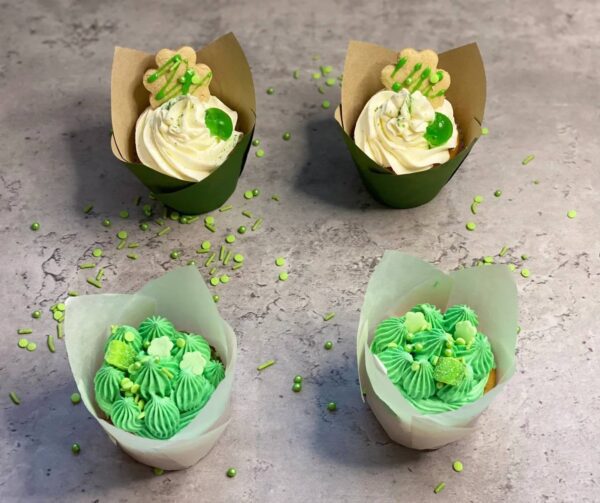 Four green-themed cupcakes