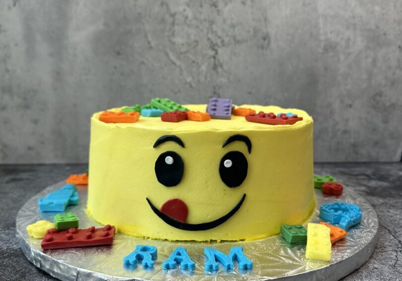 A yellow color smiley shapes cake
